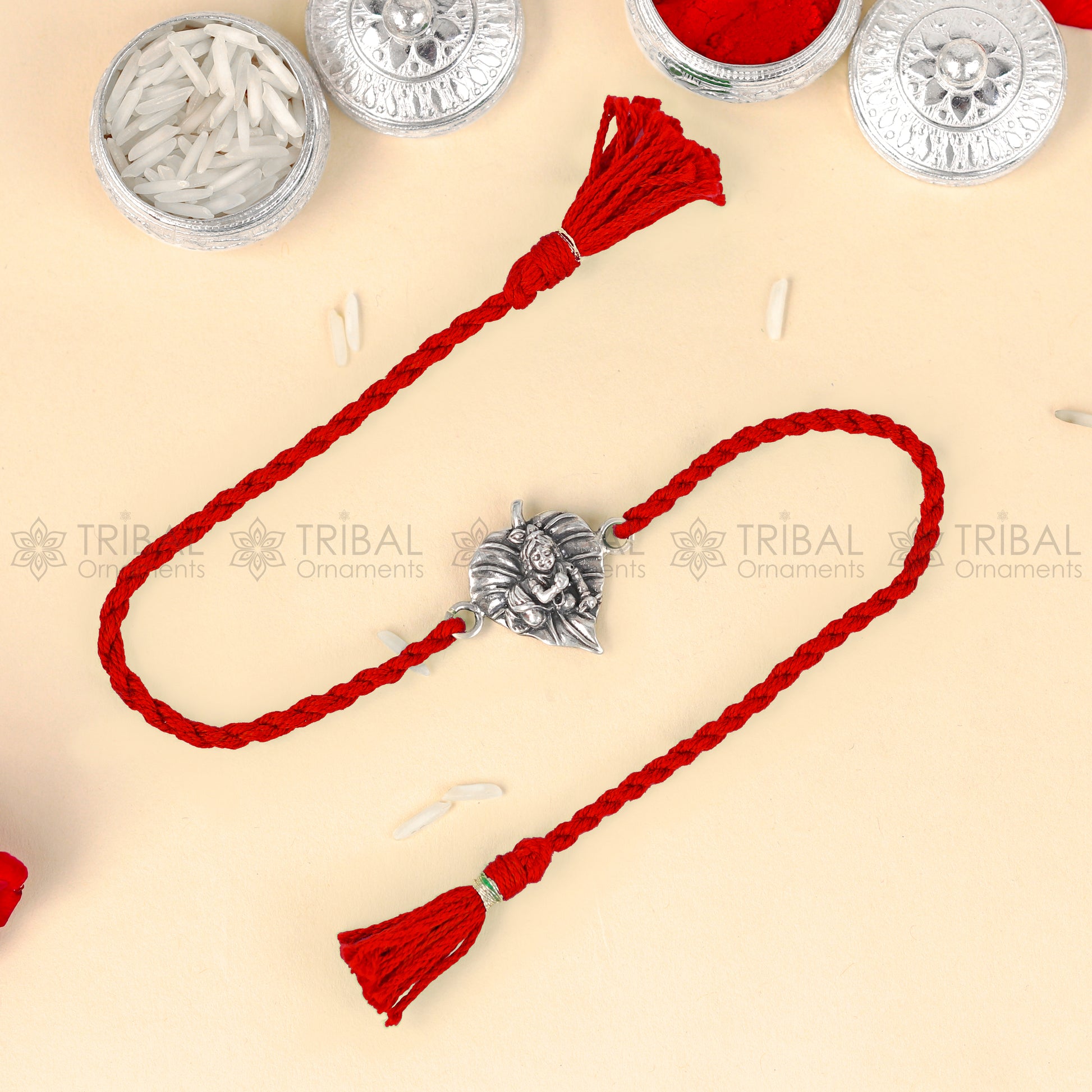 925 Sterling silver Lord Laddu Gopala design thread bracelet with red thread from TRIBAL ORNAMENTS featuring a detailed pendant.