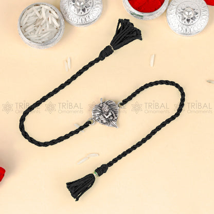 Sterling silver Lord Laddu Gopala design thread bracelet with red thread and pendant, crafted by TRIBAL ORNAMENTS.