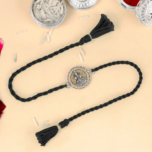 925 Sterling silver Lord Laxmi ji design thread rakhi bracelet with red thread from TRIBAL ORNAMENTS, featuring intricate pendant details.