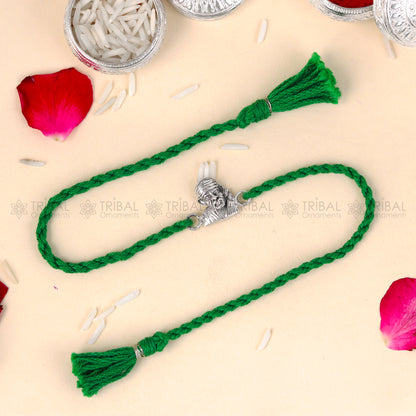 Sterling silver Lord Om Sai Ram thread bracelet by TRIBAL ORNAMENTS with red thread and Om Sai Ram pendant design.