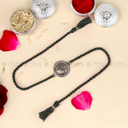 Sterling silver Lord Om Shiv mantra design thread bracelet with red thread from TRIBAL ORNAMENTS featuring pendant detail.