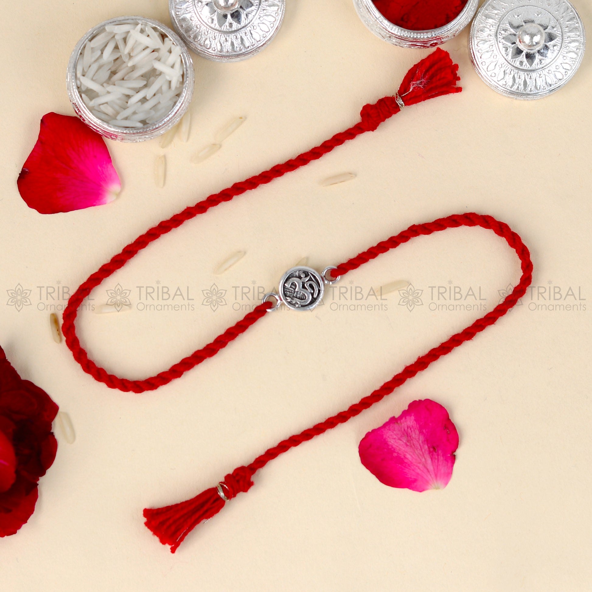 Sterling silver Lord Om Shiv mantra design thread bracelet with red thread from TRIBAL ORNAMENTS, featuring a pendant.