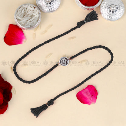 Sterling silver Lord Om Shiva mantra design bracelet with red thread from TRIBAL ORNAMENTS featuring a detailed pendant.
