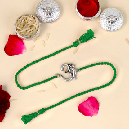 Sterling silver Lord Om Shiv mantra design bracelet with red thread from TRIBAL ORNAMENTS, featuring a detailed pendant.