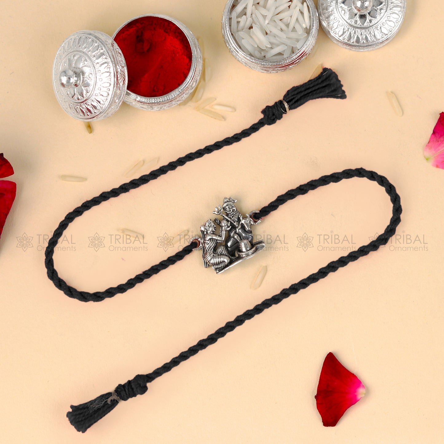 Sterling silver Lord Parwati and Nandi Maharaj bracelet with Shiva Lingam design on red thread, from TRIBAL ORNAMENTS.
