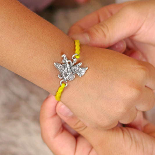 925 Sterling silver Lord Saraswati Maa bracelet with veena design and red thread, crafted by TRIBAL ORNAMENTS.