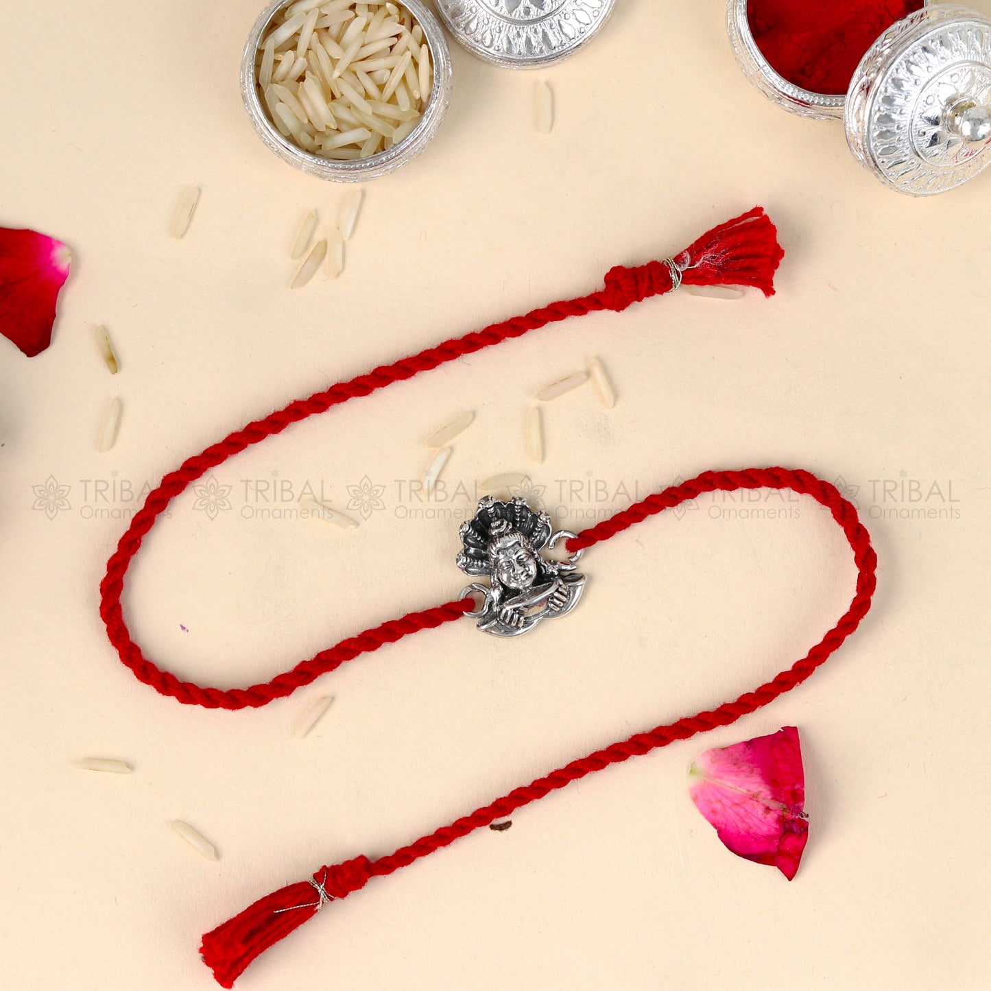 Sterling silver Lord Shiva design thread bracelet by TRIBAL ORNAMENTS with red thread accents and intricate silver detailing.