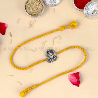 925 Sterling silver Lord Shiva design thread rakhi bracelet with red thread from TRIBAL ORNAMENTS, featuring intricate silver craftsmanship.