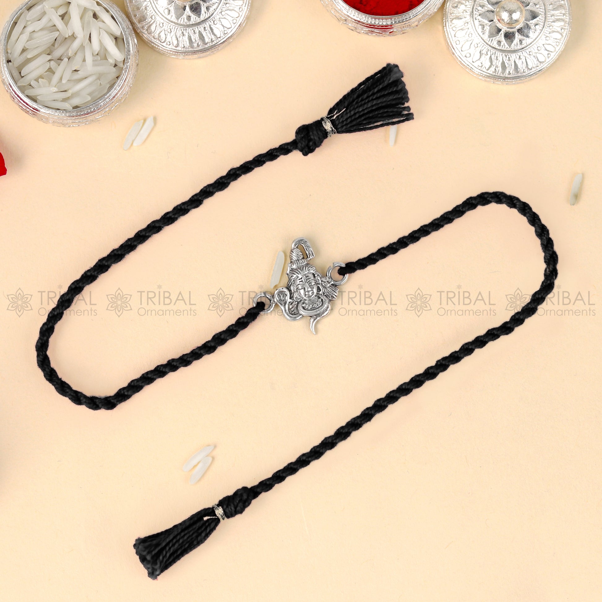 925 Sterling silver Lord Shiva design thread bracelet with red thread and Mahadeva pendant from TRIBAL ORNAMENTS.