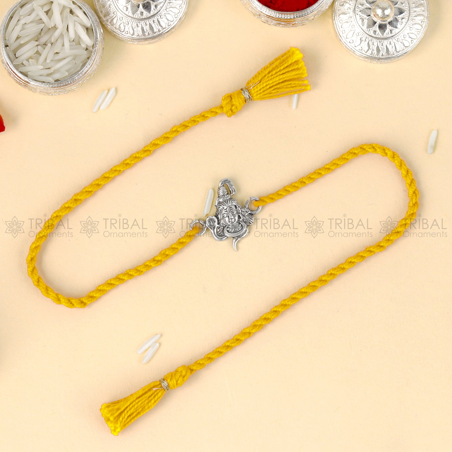 Sterling silver Lord Shiva design thread bracelet with red thread and Mahadeva pendant from TRIBAL ORNAMENTS.