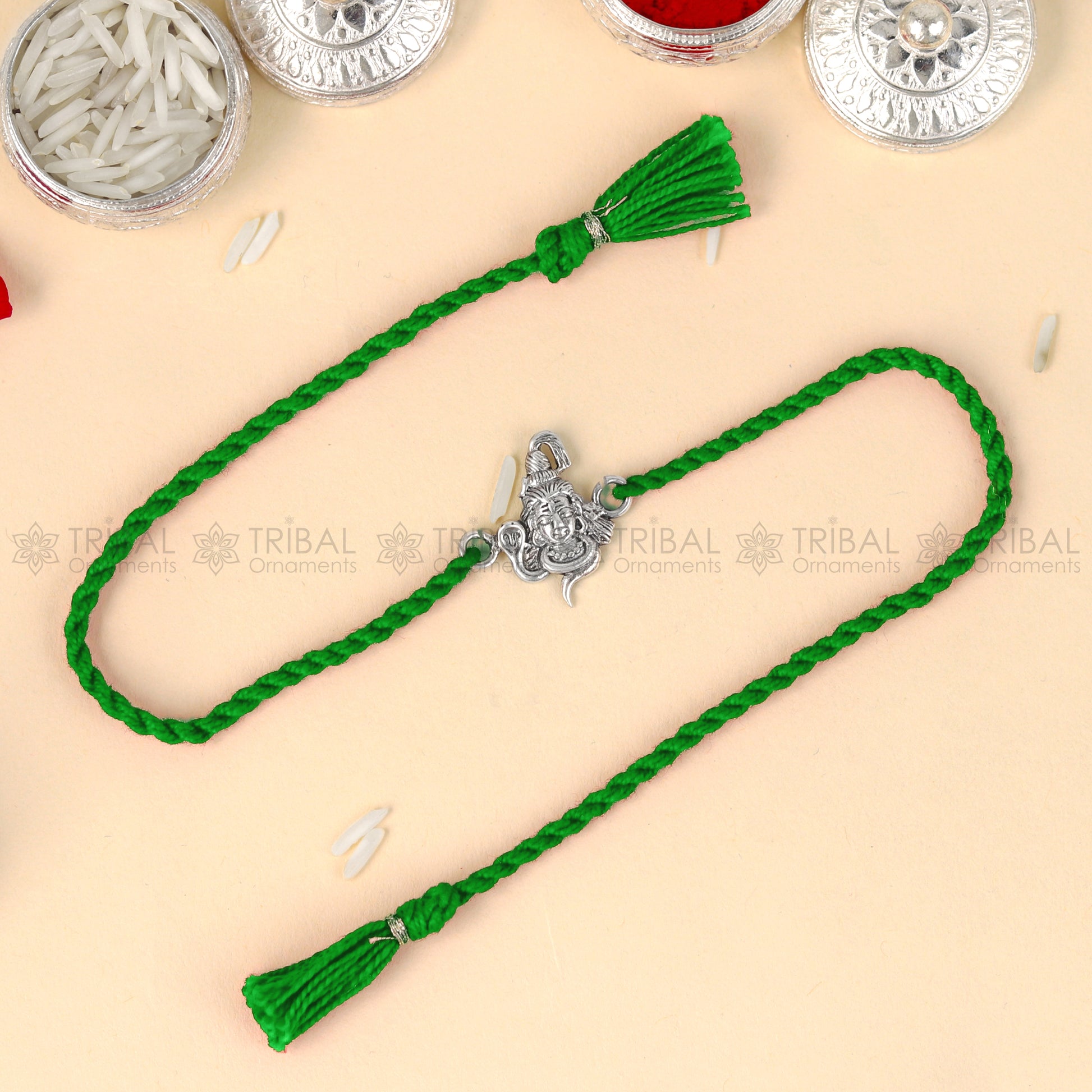Sterling silver Lord Shiva design thread bracelet by TRIBAL ORNAMENTS with red thread and Mahadeva pendant.