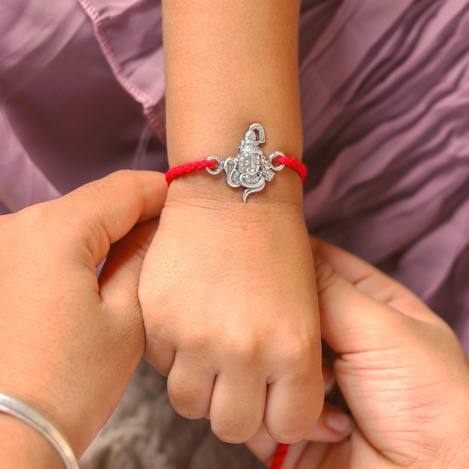 925 Sterling silver Lord Shiva design thread bracelet with red thread and Mahadeva pendant by Tribal Ornaments.