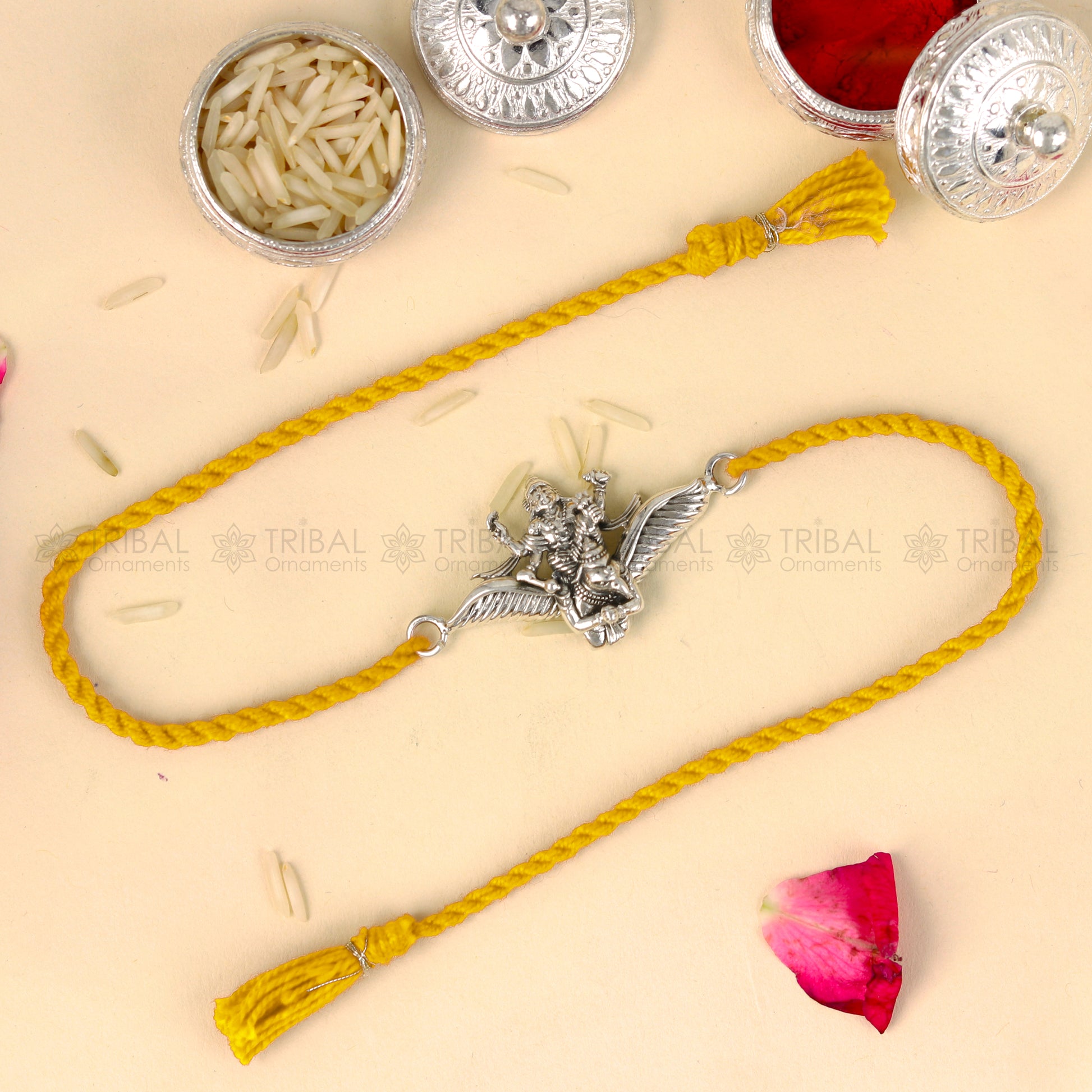 Sterling silver Lord Vishnu with Garuda design thread bracelet by TRIBAL ORNAMENTS featuring red thread and intricate pendant design.