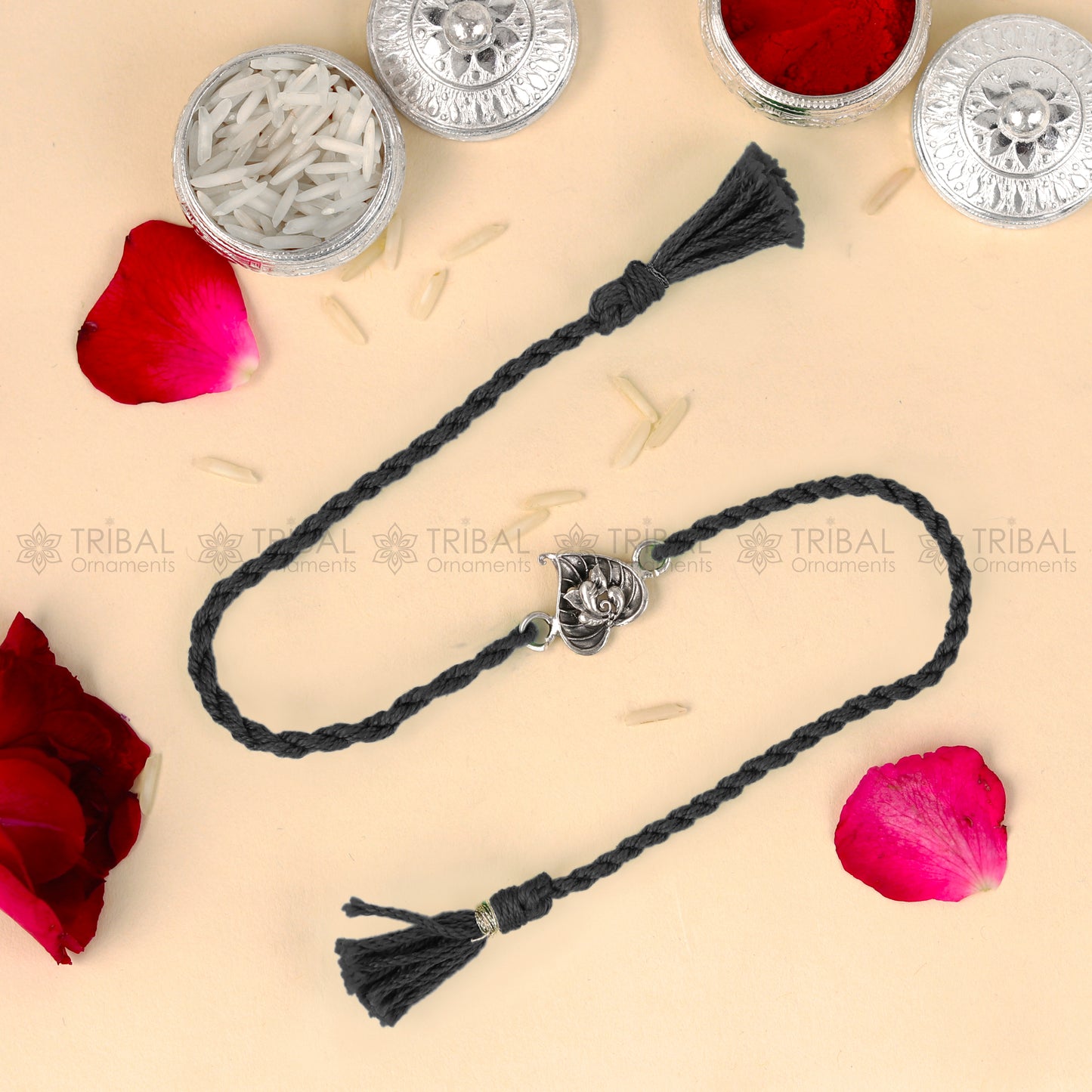 Sterling silver Lord Ganesha bracelet with red thread and pan design pendant from TRIBAL ORNAMENTS.