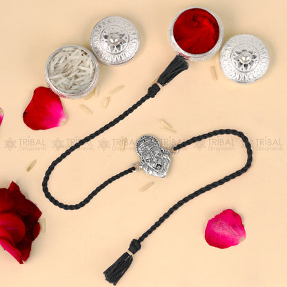 Sterling silver Narsimha design thread bracelet with red thread and pendant, crafted by TRIBAL ORNAMENTS.