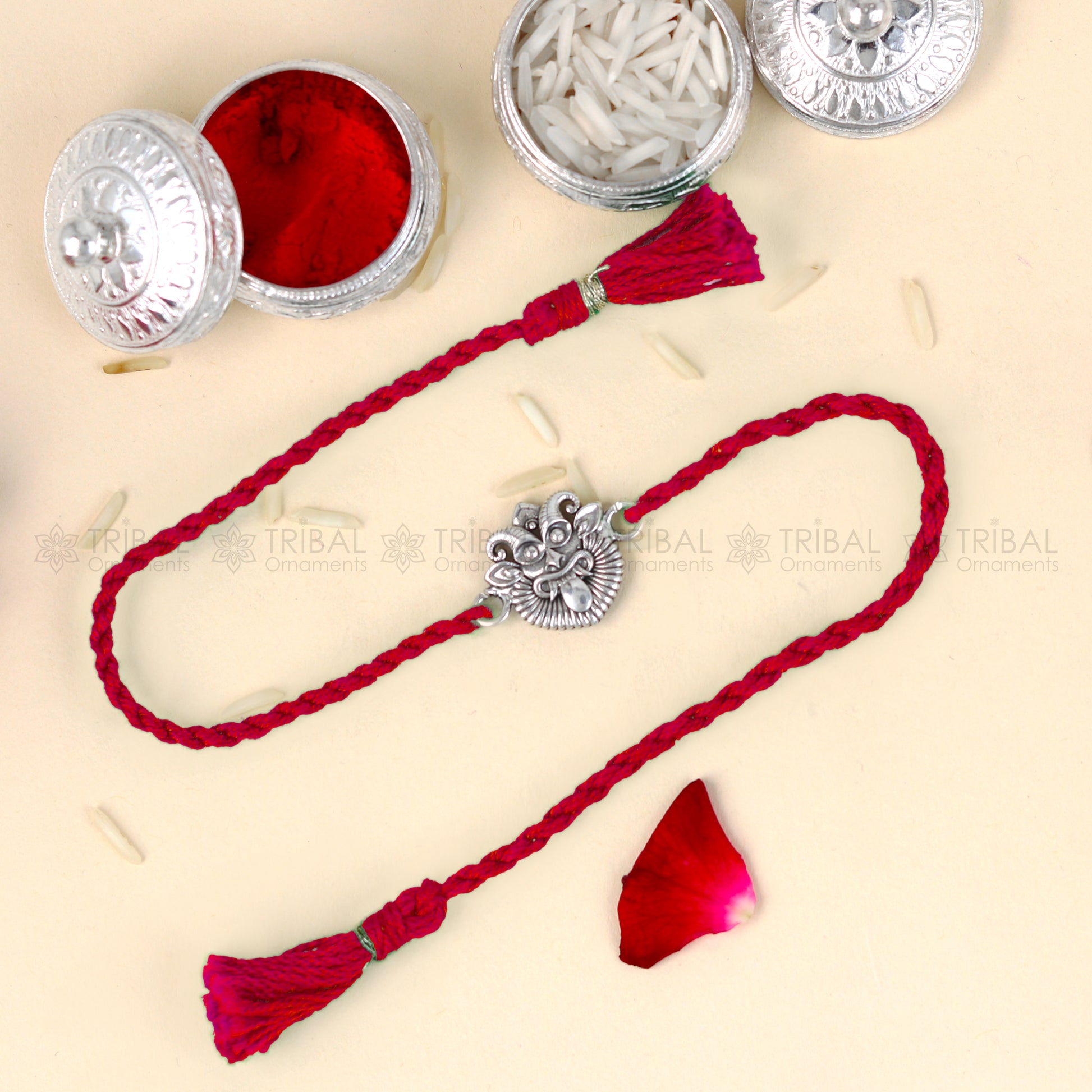 925 Sterling silver rakhi bracelet with red thread and Nazar Battu design from Tribal Ornaments, featuring a traditional pendant.