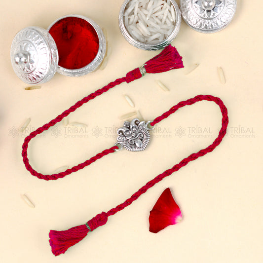 925 Sterling silver rakhi bracelet with red thread and Nazar Battu design from Tribal Ornaments, featuring a traditional pendant.