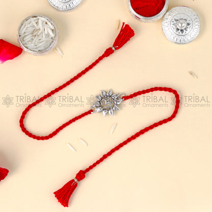 925 Sterling silver Om design thread rakhi bracelet with red thread and silver pendant, handcrafted by TRIBAL ORNAMENTS.