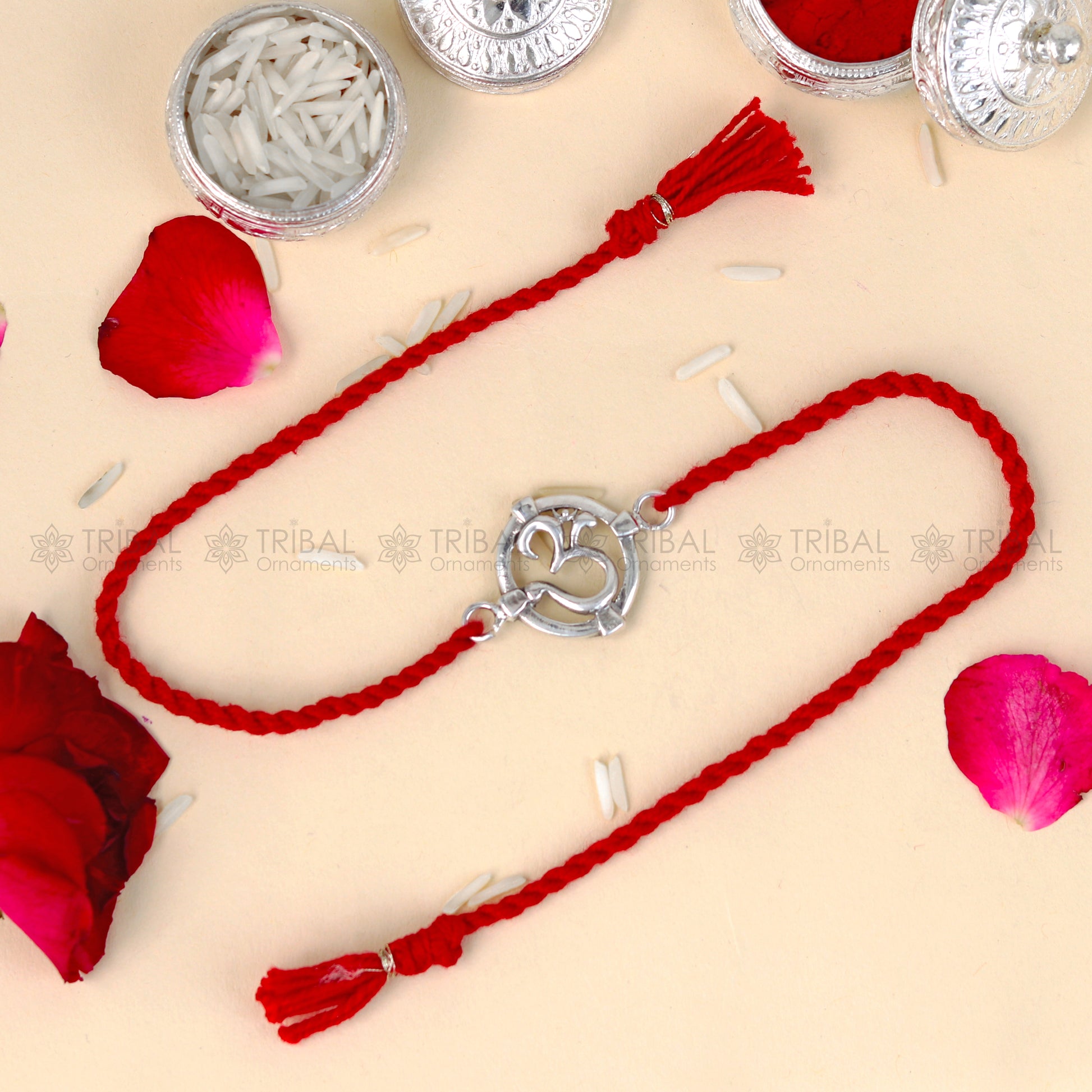 Sterling silver Om design thread bracelet with red thread and pendant, crafted by TRIBAL ORNAMENTS.