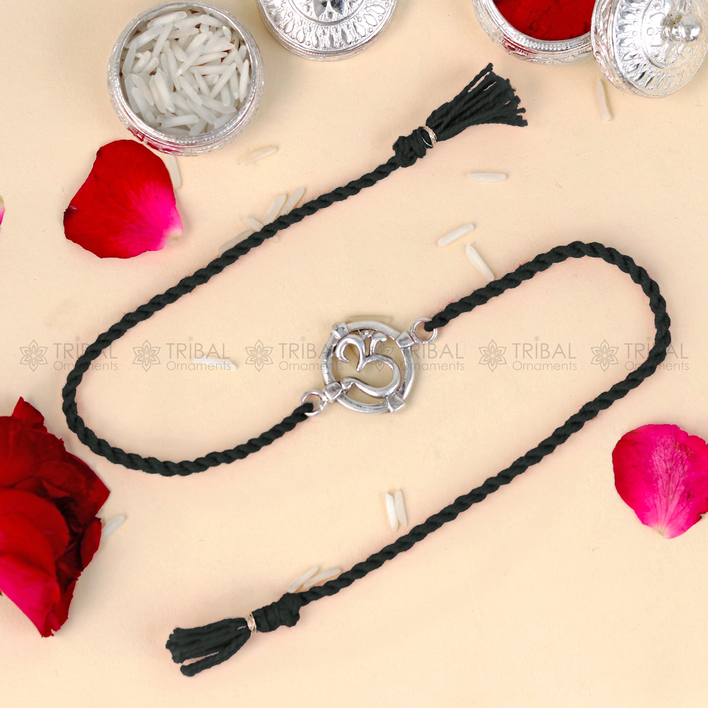 925 Sterling silver Om design thread bracelet with red thread from TRIBAL ORNAMENTS, featuring a pendant in a traditional style.