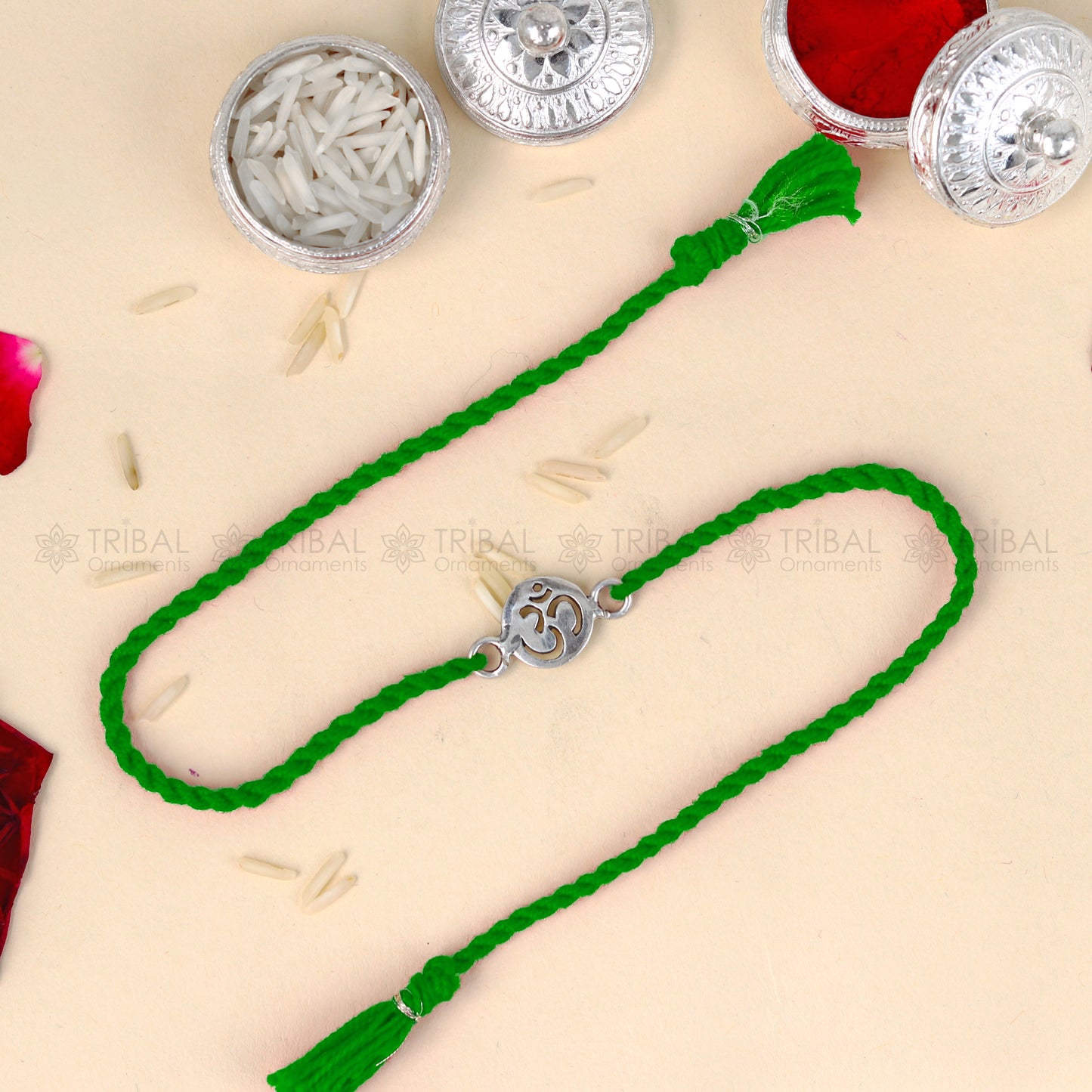 Sterling silver OM design thread rakhi bracelet with red thread and pendant, by TRIBAL ORNAMENTS.