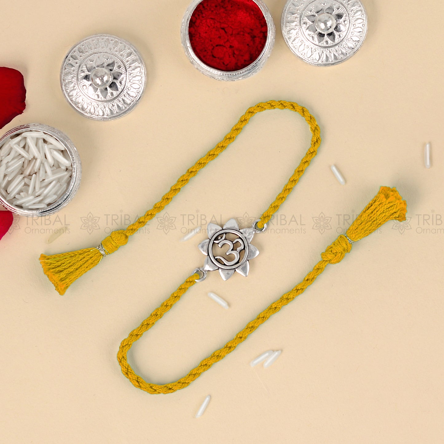 Sterling silver Om design thread bracelet with red thread from TRIBAL ORNAMENTS, ideal for Rakshabandhan festival.