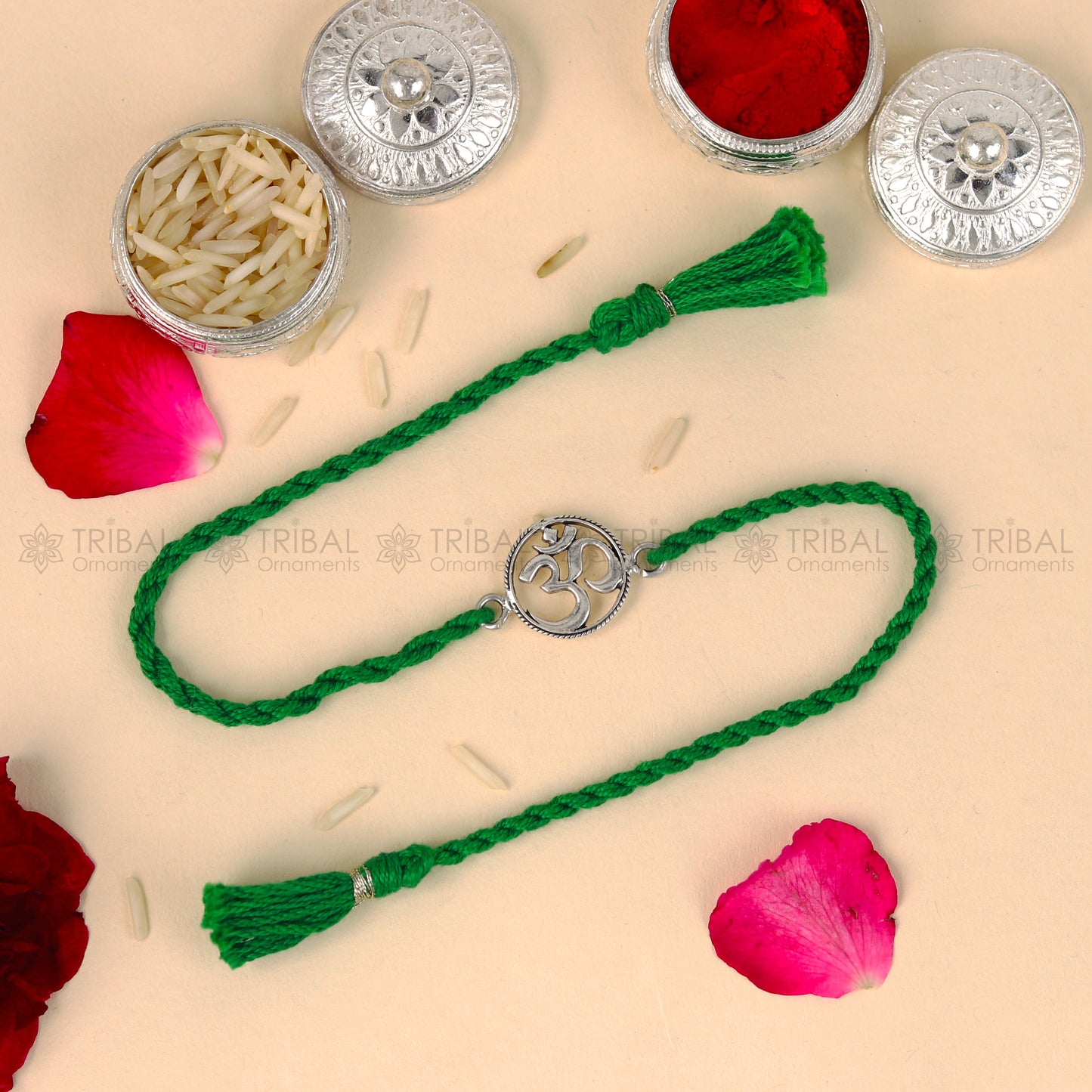 Sterling silver OM design bracelet by Tribal Ornaments with red thread, featuring a pendant for Rakshabandhan festival.