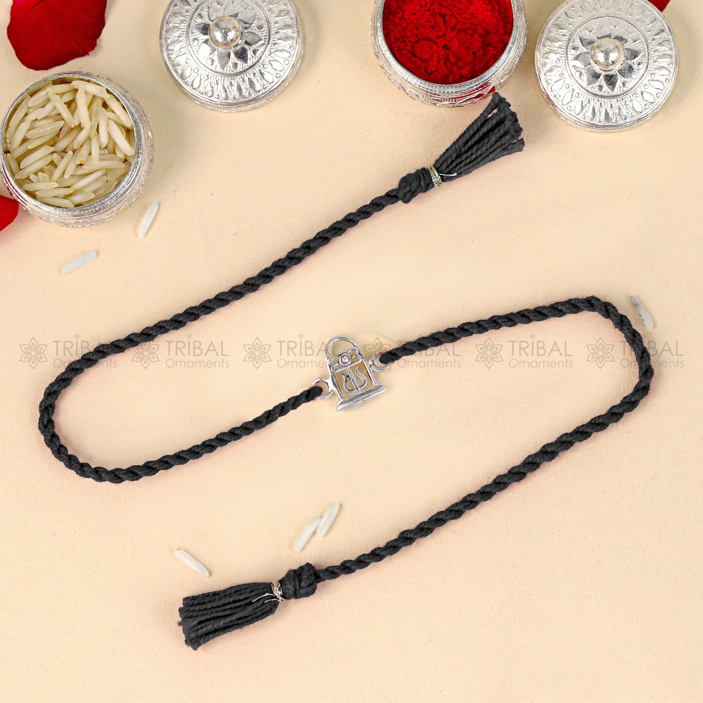 Sterling silver Siva Lingam design thread bracelet with red thread, crafted by Tribal Ornaments for spiritual elegance.