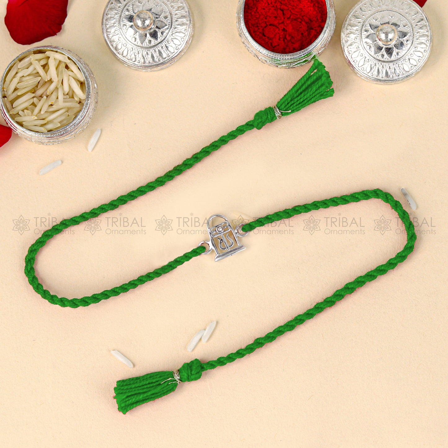 Sterling silver Siva Lingam design thread bracelet with red thread and pendant, crafted by TRIBAL ORNAMENTS.