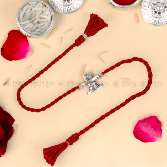 Sterling silver Siva lingam design thread bracelet with red thread, crafted by TRIBAL ORNAMENTS.