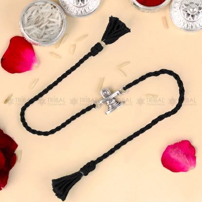 Sterling silver Siva Lingam design thread bracelet with red thread and pendant, from TRIBAL ORNAMENTS.