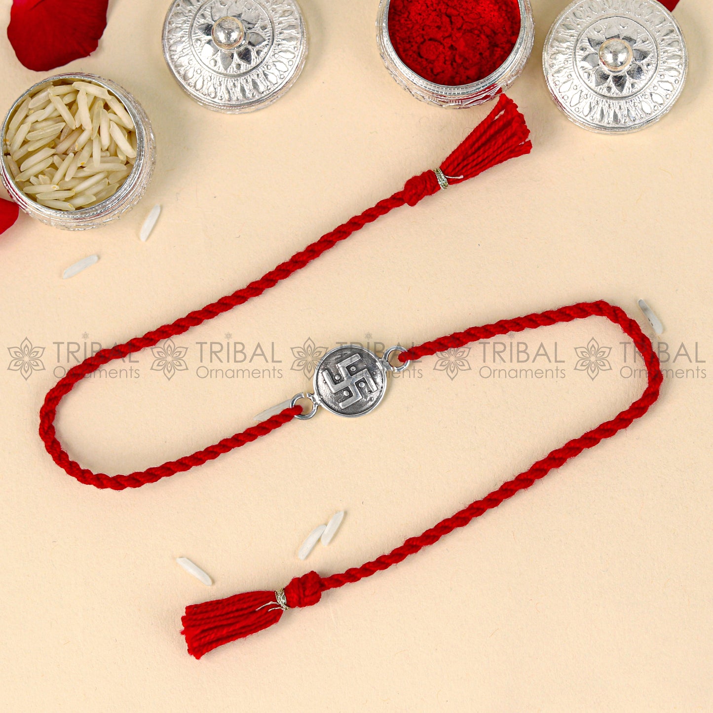 Sterling silver Swashtik design thread rakhi bracelet with red thread and pendant from TRIBAL ORNAMENTS.