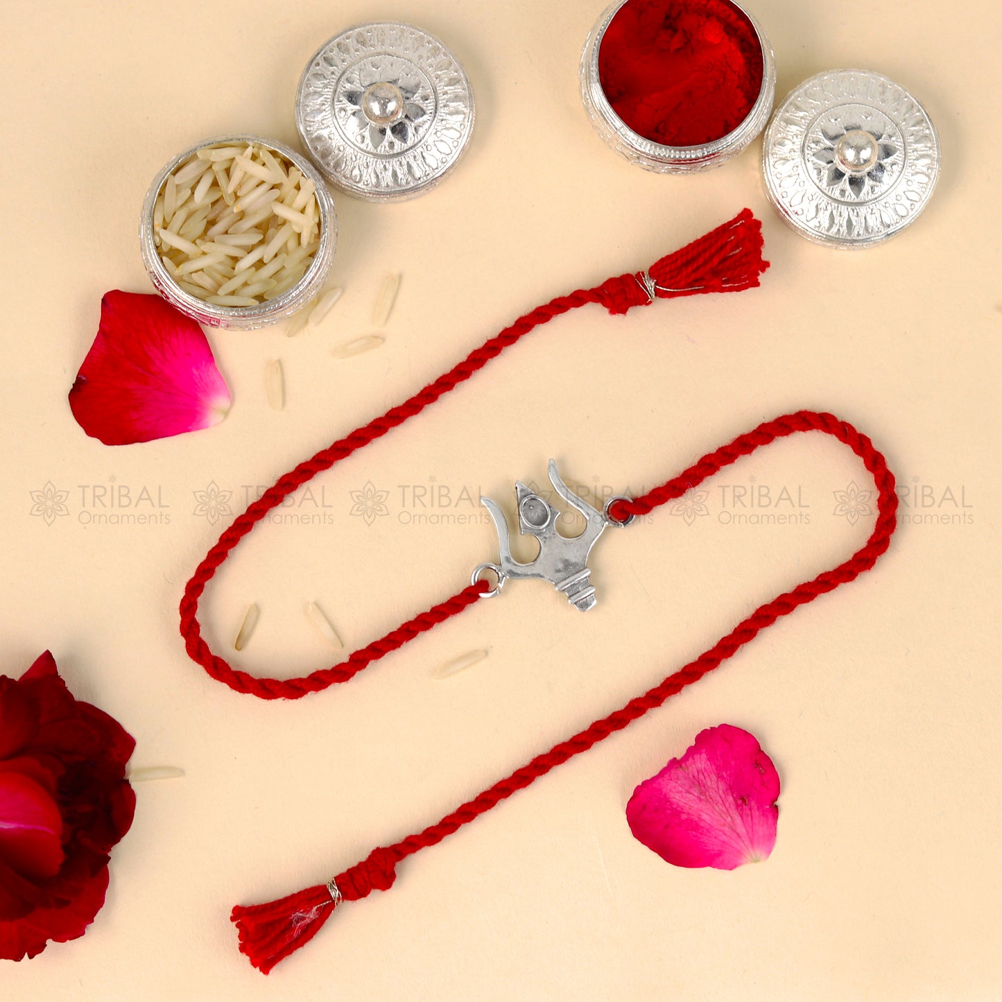 Sterling silver Trishul bracelet with red thread and trident pendant, tribal-inspired design for Rakshabandhan festival.