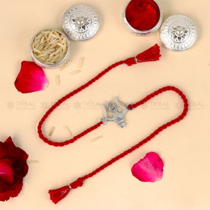Sterling silver Trishul bracelet with red thread and trident pendant, tribal-inspired design for Rakshabandhan festival.
