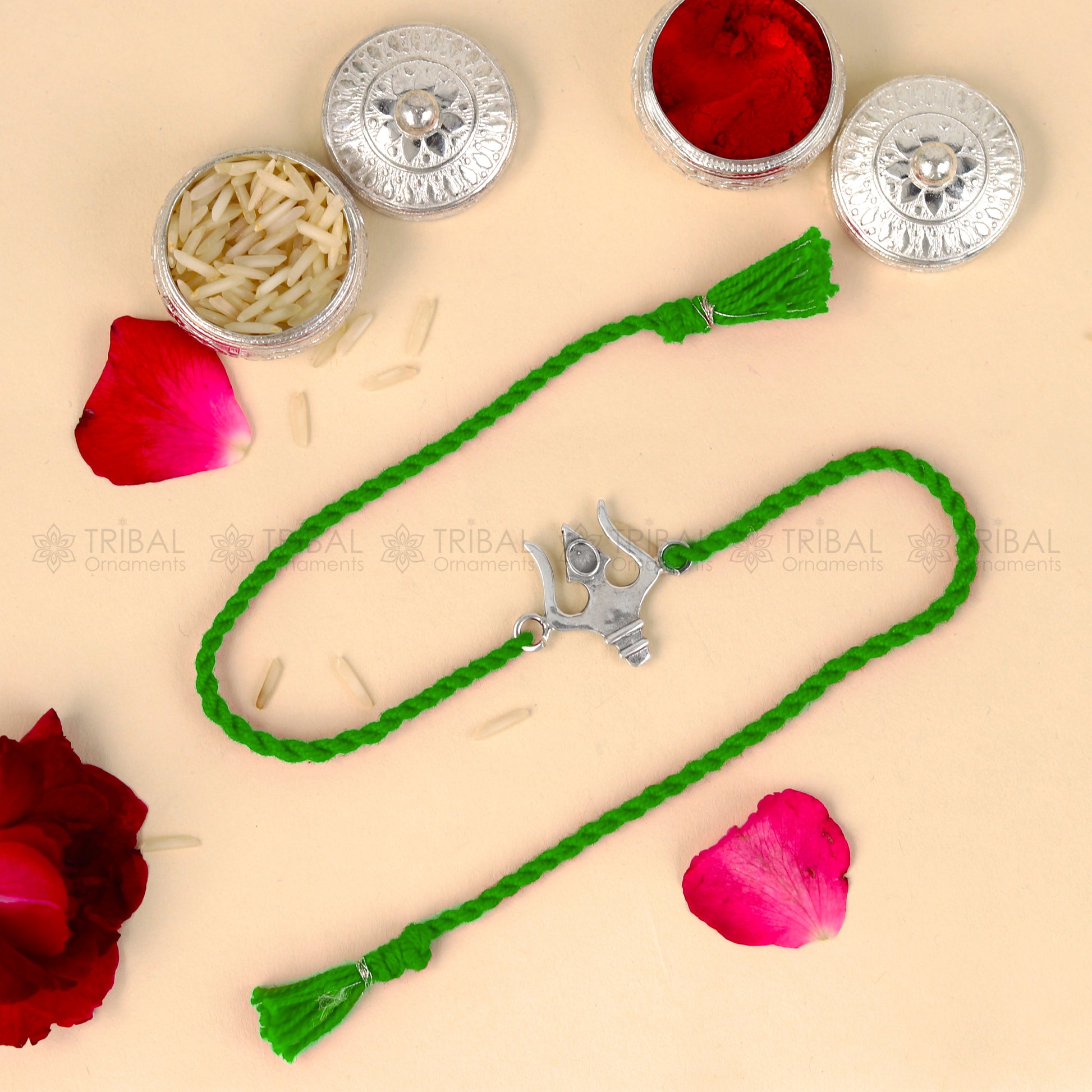 Sterling silver Trishul bracelet with red thread and trident pendant from TRIBAL ORNAMENTS, ideal for Rakshabandhan festival.