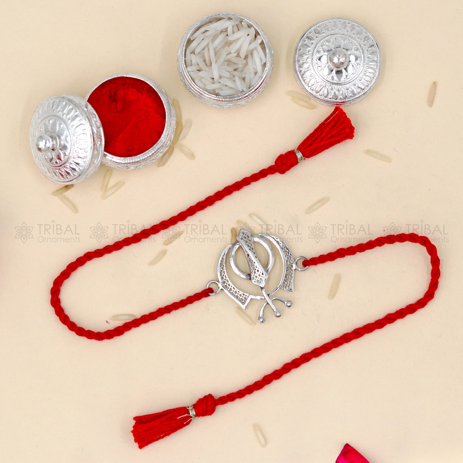 Sterling silver Khalsa design thread bracelet by Tribal Ornaments featuring a red thread and Wahe Guru Ji pendant.