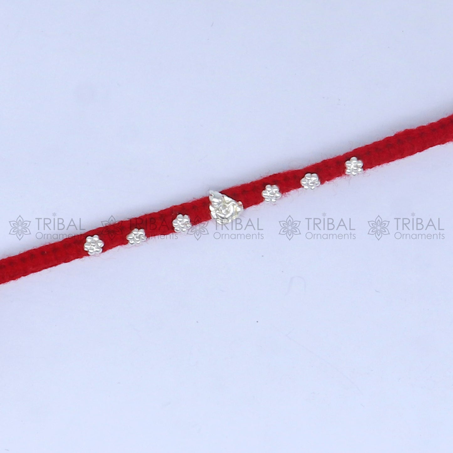 925 sterling silver Lord Ganesha thread rakhi bracelet by TRIBAL ORNAMENTS featuring Ganesha pendant for Raksha Bandhan festival.