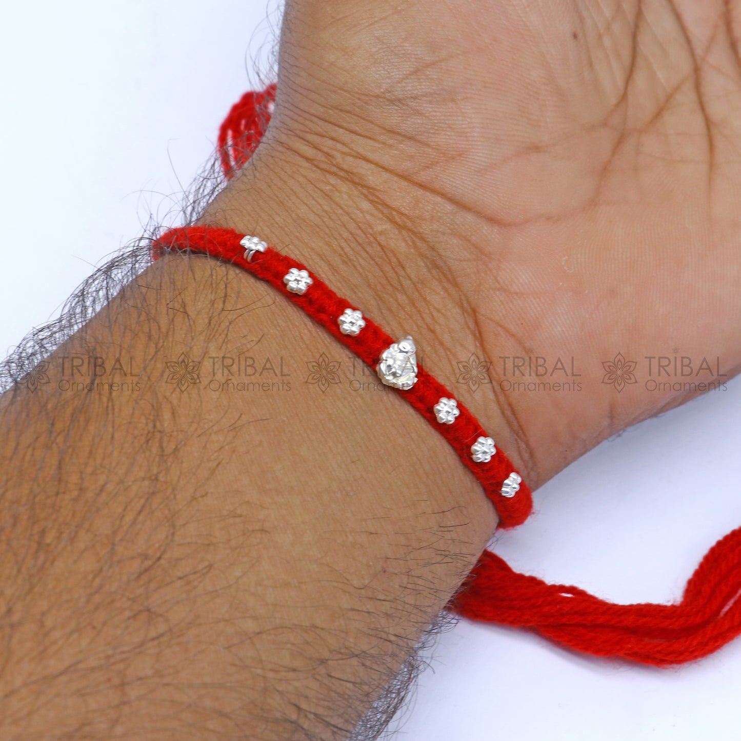 Sterling silver Lord Ganesha thread rakhi bracelet by TRIBAL ORNAMENTS with intricate Ganesha pendant design for Rakshabandhan festival.