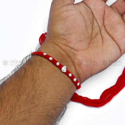 Sterling silver Lord Ganesha thread rakhi bracelet with intricate Ganesha pendant design by TRIBAL ORNAMENTS.