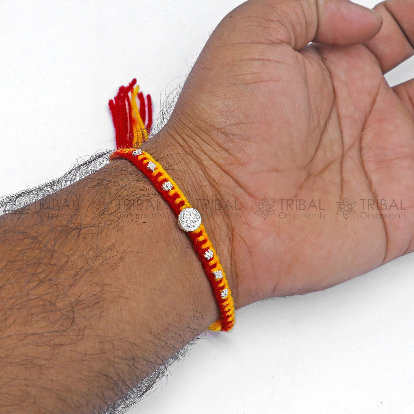 Sterling silver Lord Ganesha design thread rakhi bracelet from TRIBAL ORNAMENTS featuring intricate pendant for Rakshabandhan.