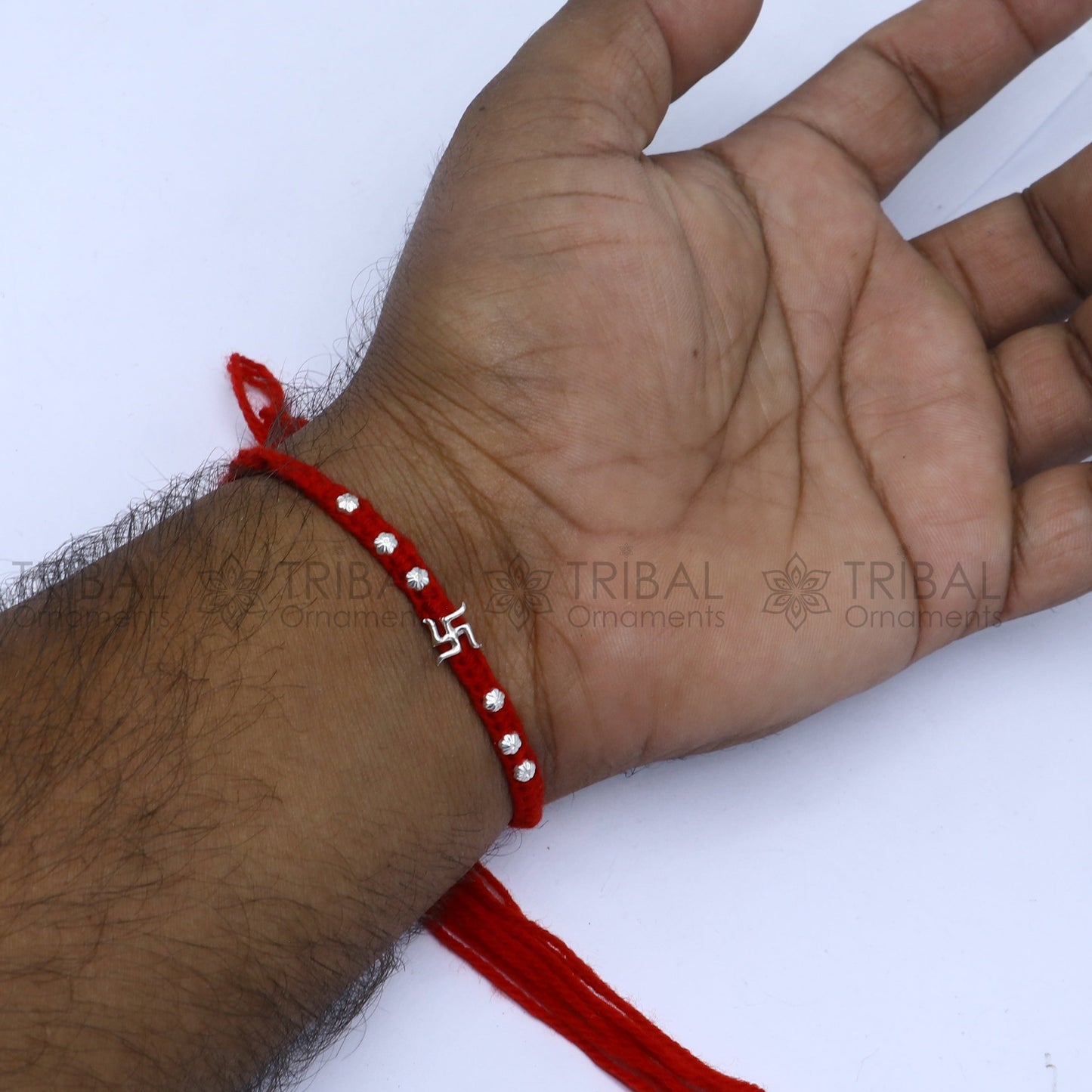 Sterling silver Swashtik design thread rakhi bracelet by TRIBAL ORNAMENTS with intricate pendant for Rakshabandhan.