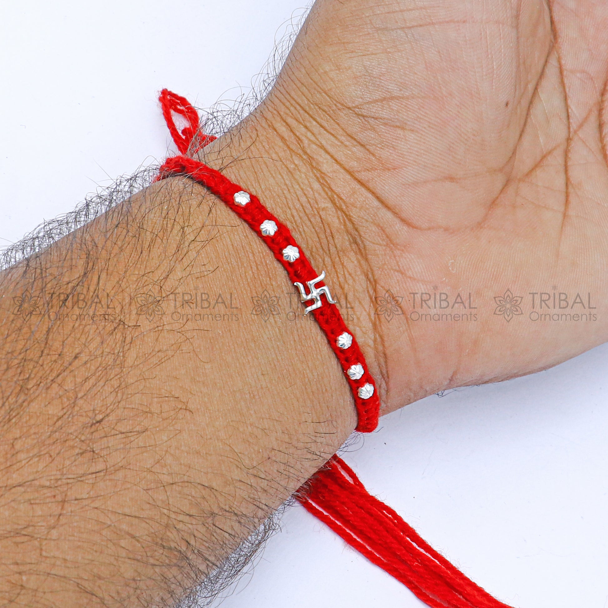 Sterling silver Swashtik design thread rakhi bracelet by TRIBAL ORNAMENTS with pendant for Rakshabandhan festival.
