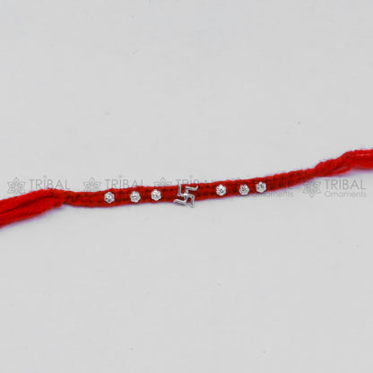 Sterling silver Swashtik design thread rakhi bracelet by TRIBAL ORNAMENTS with intricate pendant for Rakshabandhan festival.