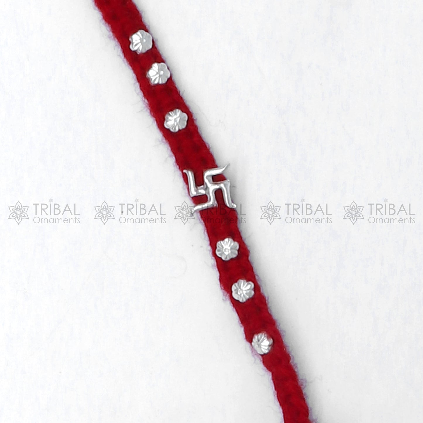 925 sterling silver Swashtik design thread rakhi bracelet by TRIBAL ORNAMENTS featuring a decorative pendant for Rakshabandhan.