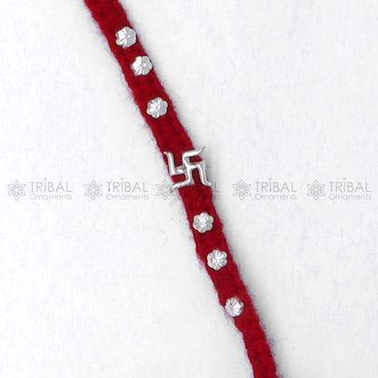 925 sterling silver Swashtik design thread rakhi bracelet by TRIBAL ORNAMENTS featuring a decorative pendant for Rakshabandhan.