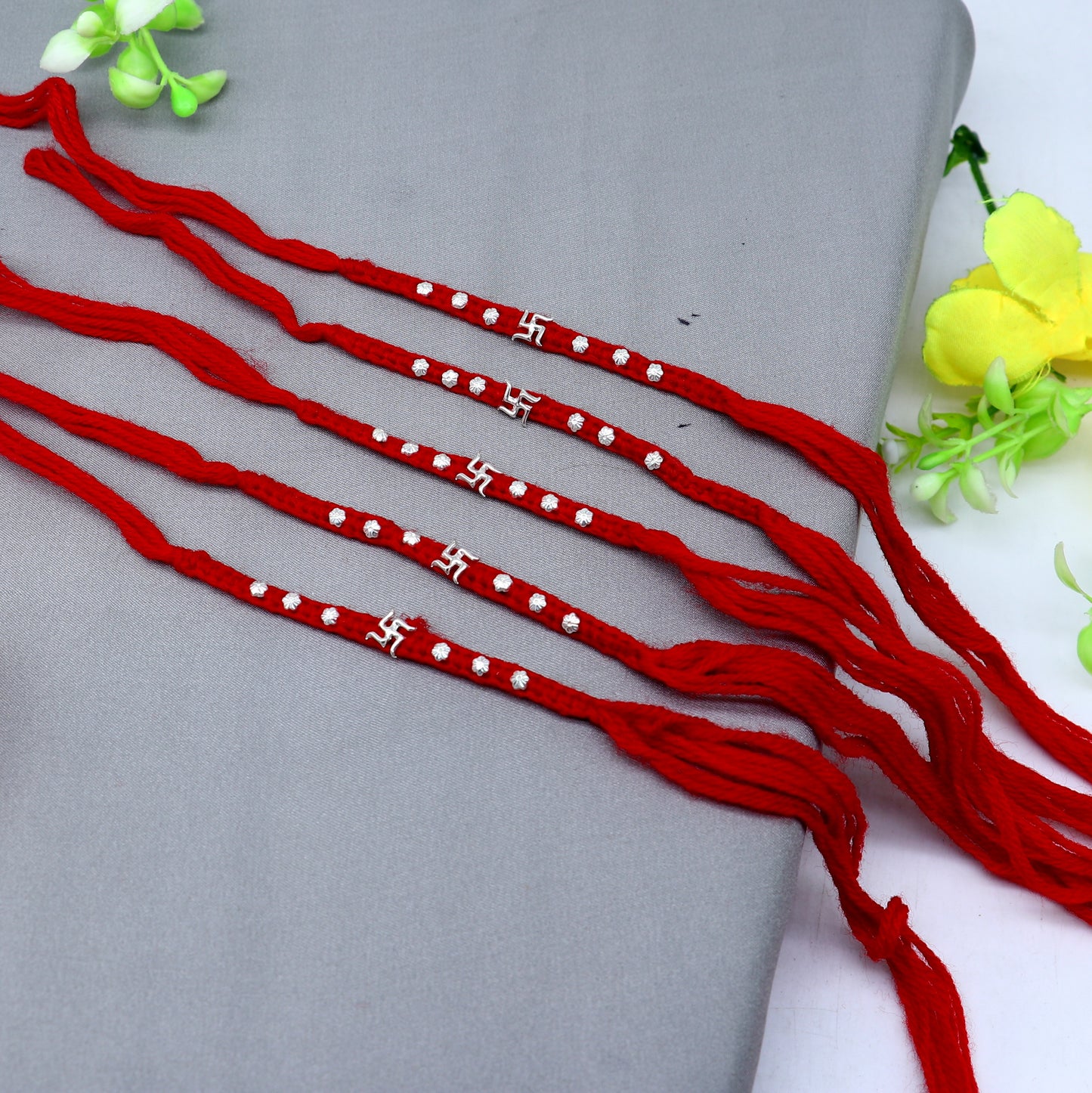 Sterling silver Swashtik design thread rakhi bracelet by TRIBAL ORNAMENTS with intricate pendant for Rakshabandhan festival.