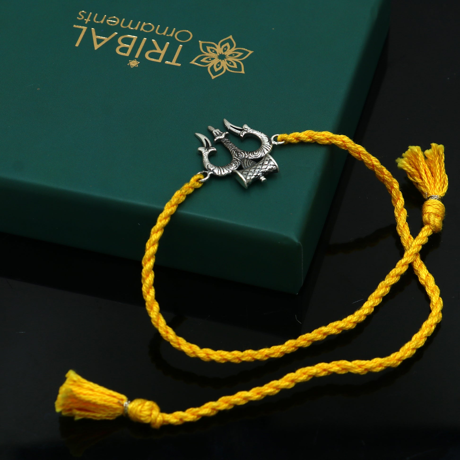 Sterling silver Trishul thread rakhi bracelet with trident pendant by TRIBAL ORNAMENTS, perfect for Rakshabandhan festival.