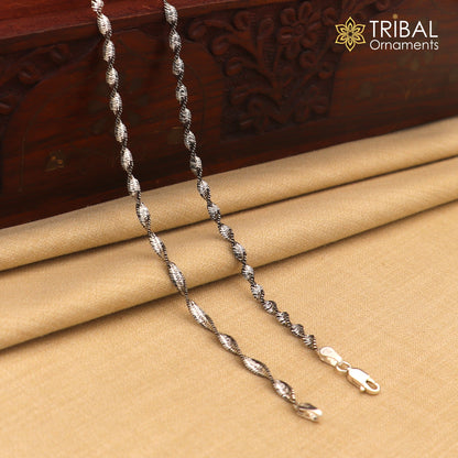 Sterling silver twisting chain anklet bracelet by Tribal Ornaments, lightweight ankle jewelry with intricate design and shiny finish.