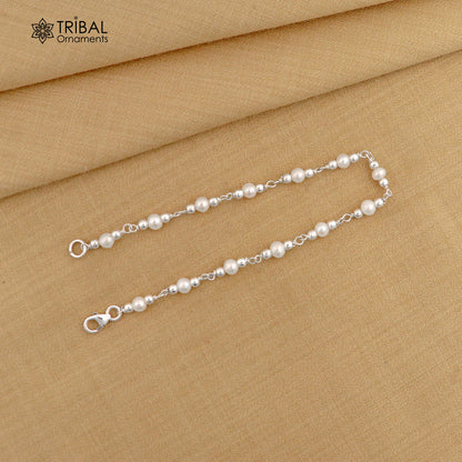 Handmade 7.5-inch sterling silver beaded bracelet with natural pearl accents, unisex jewelry by TRIBAL ORNAMENTS.