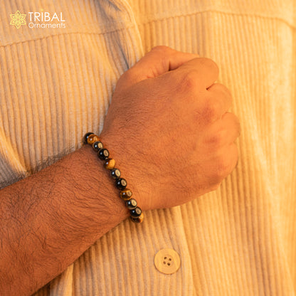 Handmade unisex bracelet with 8mm tiger eye gemstone beads, crafted by TRIBAL ORNAMENTS for customized jewelry style.
